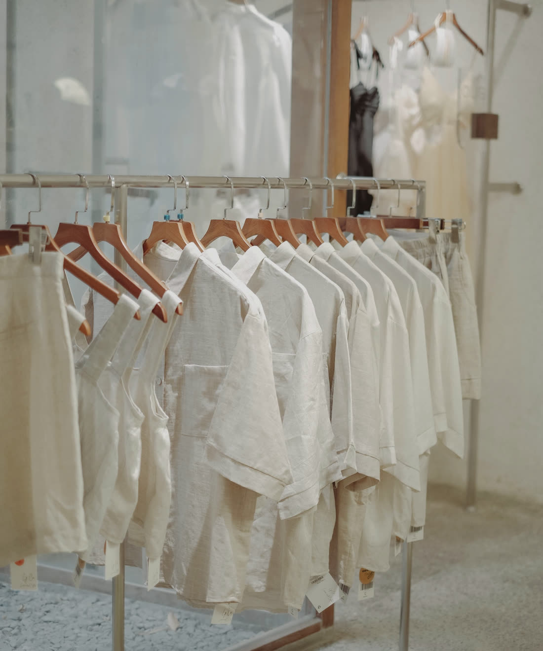 Shirts on wooden hangers in a clothing store