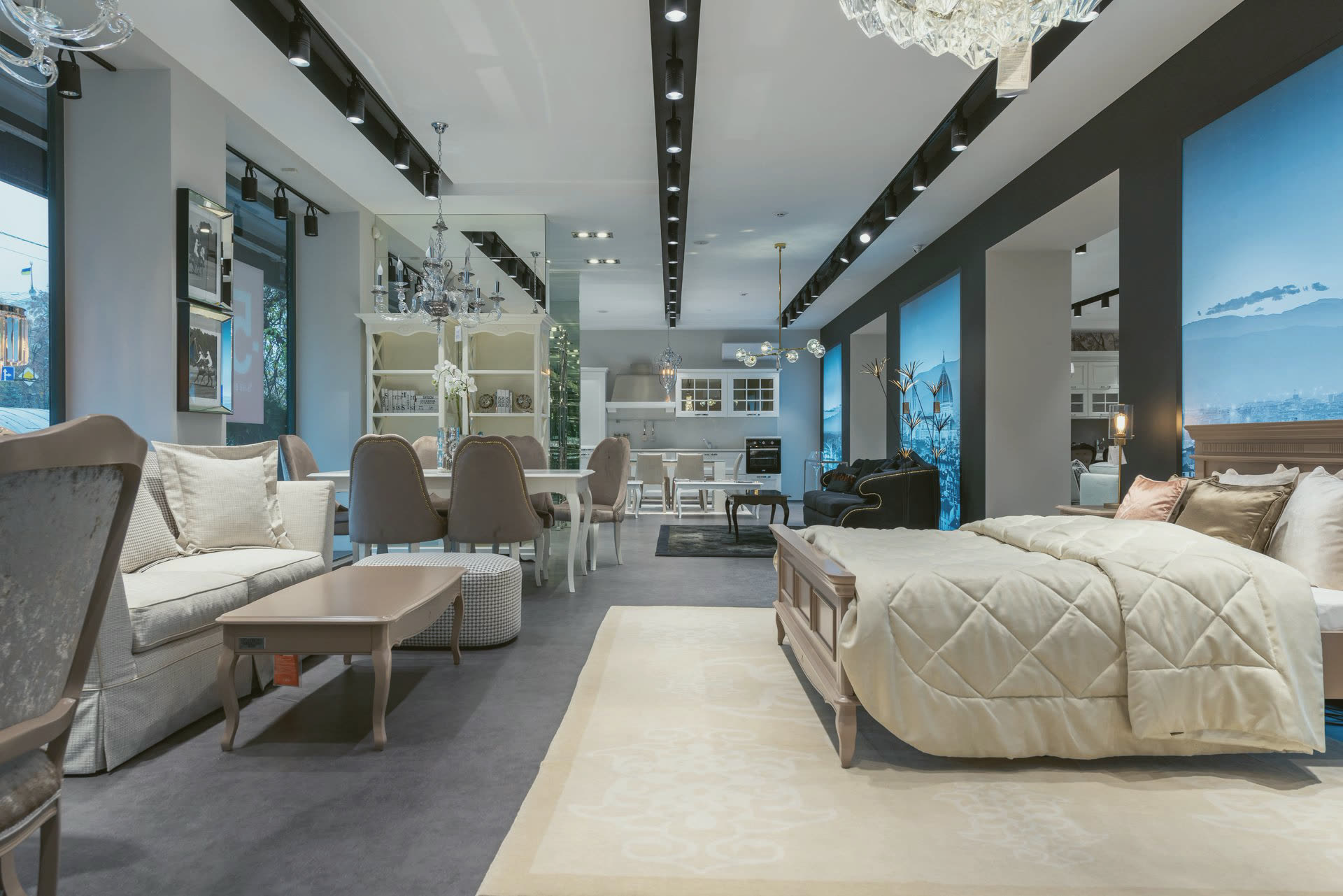 A furniture showroom with a bed, sofa and dining chairs