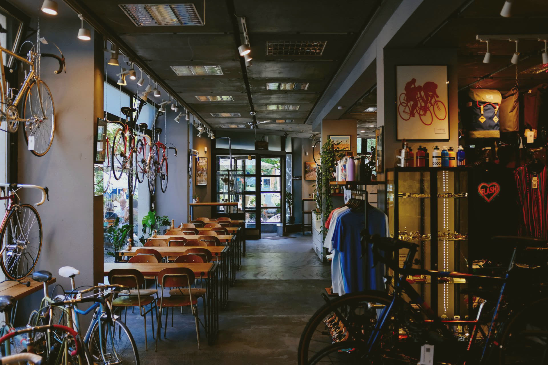 A bicycle shop with bikes on the walls and cycling gear on racks