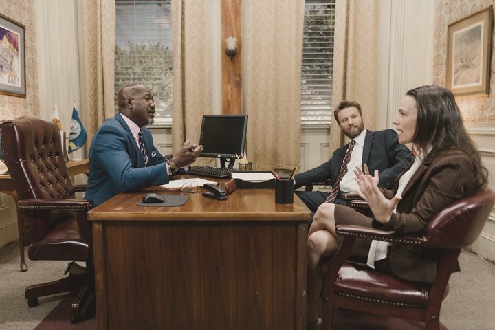 Lawyers meeting with a client in their office